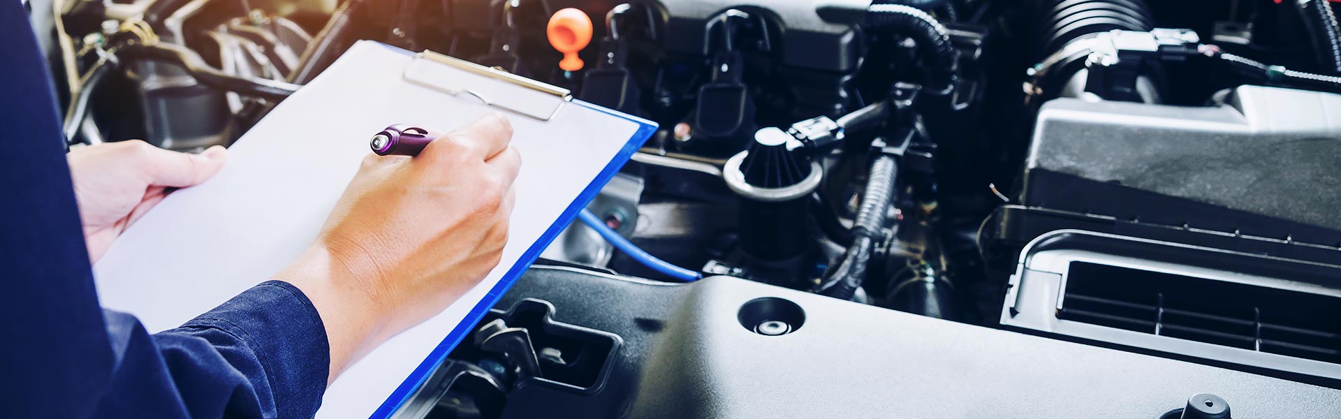 service tech inspecting vehicle